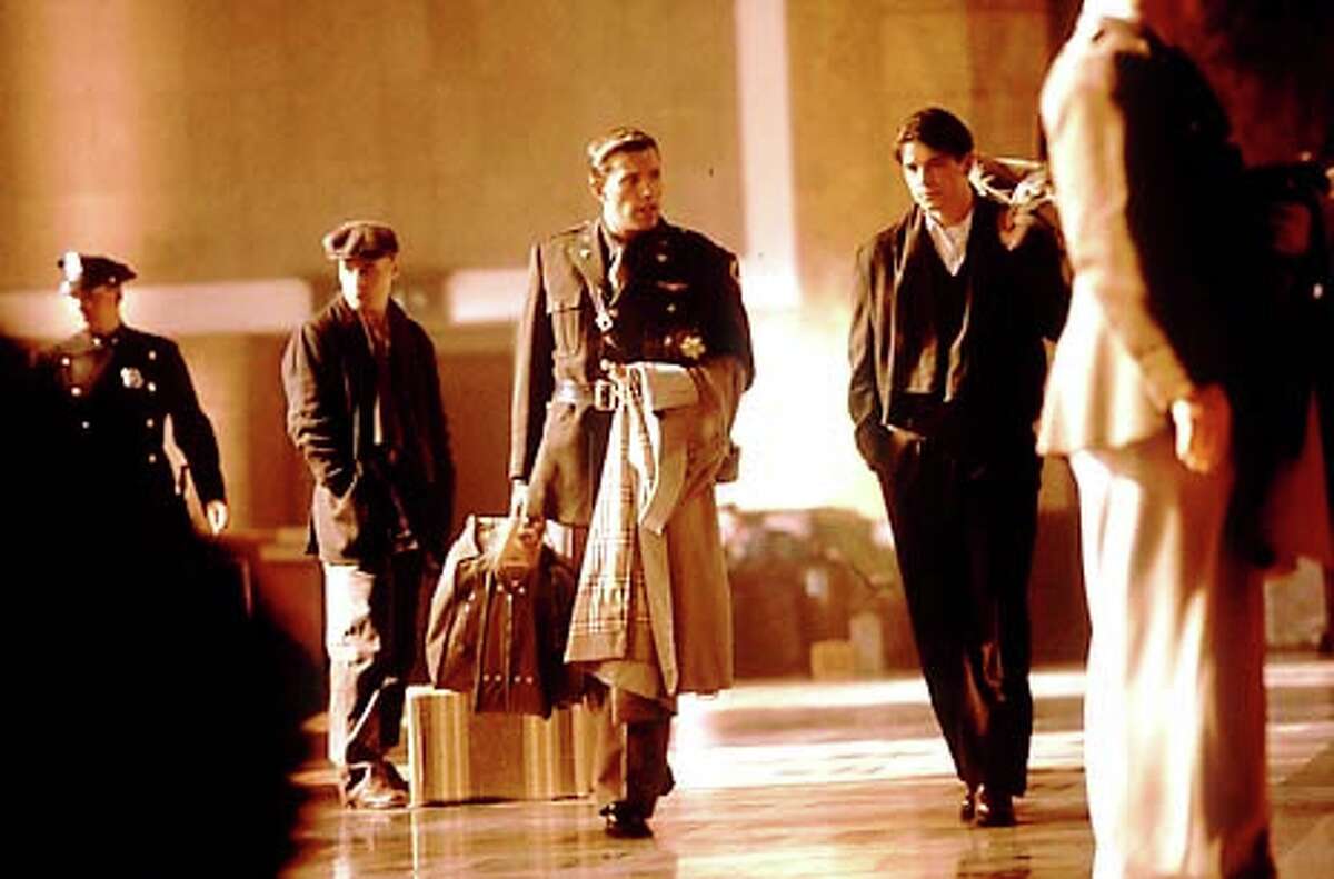 Hoben Affleck with raincoat, center, co-stars as Rafe McCawley with Jose Hartnett, right, as Danny Walker in Touchstone Pictures/Jerry Bruckheimer Films' epic drama "Pearl Harbor."