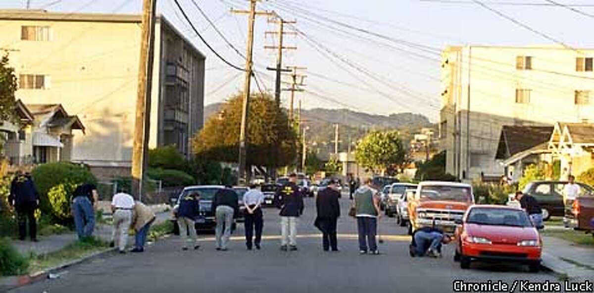 Police and FBI agents look for evidence on Thornton Street in San Leandro, near the Santos Linguisa Factory, where three government meat inspectors were shot and killed Wednesday afternoon. Chronicle photo by Kendra Luck