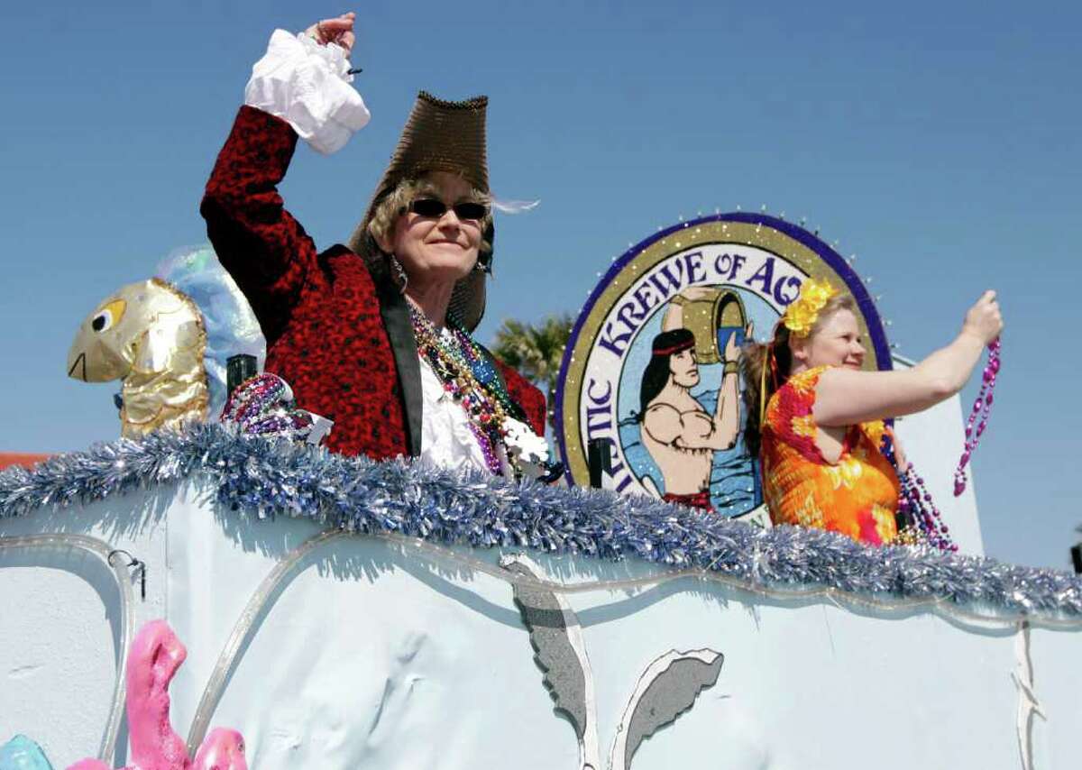 Float riders throw beads to the crowd during the Mystic Krewe of Aquarius 25th Annual Mardi Gras Kick-off Parade along Seawall Boulevard in Galveston, Texas on Saturday afternoon February 11, 2012. (AP Photo/The Galveston County Daily News, Kevin M. Cox) MANDATORY CREDIT; TV OUT