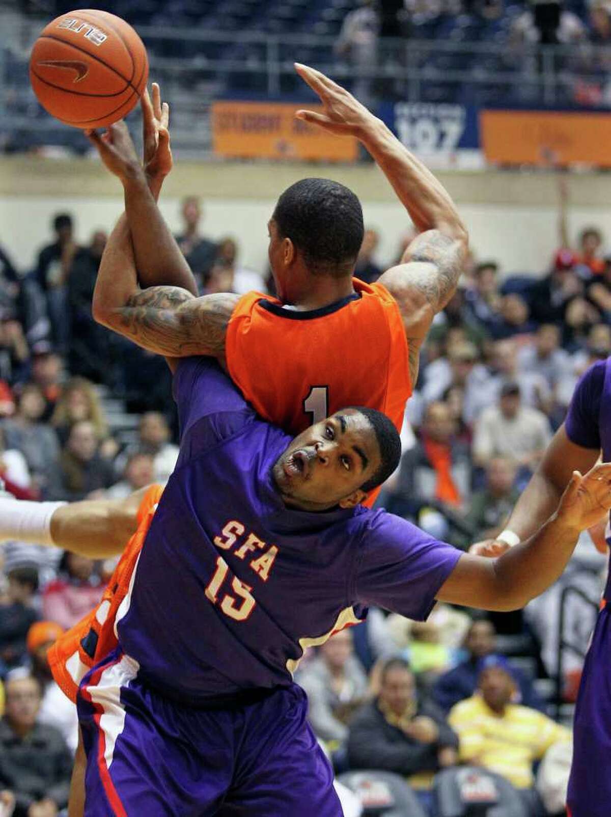 SFA's Joe Bright moves under the rebounding effort of Stephen Franklin and is called for a position foul as the Roadrunners play the SFA Lumberjacks at the UTSA Convocation Center on February 11, 2012 Tom Reel/ San Antonio Express-News