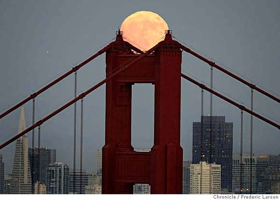 The August moon took a resting spot cradled at the top of the south tower of the Golden Gate Bridge seen from the Marin Headlands Tuesday night 8/8. The August full moon is named the sturgeon moon from fishing tribes from a large fish of the Great Lakes and other major bodies of water, were most readily caught during this month. A few tribes knew it as the Full Red Moon because, as the Moon rises, it appears reddish through any sultry haze. It was also called the Green Corn Moon or Grain Moon. 8/8/06 {Frederic Larson/The Chronicle} MANDATORY CREDIT FOR PHOTOGRAPHER AND SAN FRANCISCO CHRONICLE/ -MAGS OUT Photo: Frederic Larson