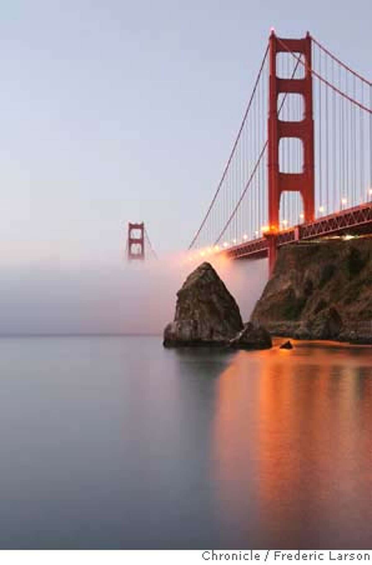 The September low hugging fog slowly makes its way under the Golden Gate Bridge seen at Fort Baker during sunrise. 9/12/06 {Frederic Larson/ The Chronicle} MANDATORY CREDIT FOR AND SAN FRANCISCO CHRONICLE/ -MAGS OUT