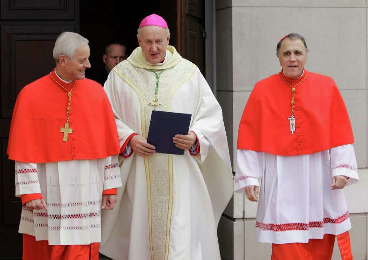 Cardinal Donald Wuerl, left, of Washington, Rev. Jeffrey N. Steenson, center, and Cardinal Daniel DiNardo, right, walk outside the Co-Cathedral of the Sacred Heart, 1111 St. Joseph Parkway, Sunday, Feb. 12, 2012, in Houston to speak with the media before the Mass of Institution for the Ordinariate of the Chair of Saint Peter. During the mass the Reverend Jeffrey Steenson was installed as the first Ordinary, or head, of the Ordinariate of the Chair of Saint Peter and given the title of Monsignor.