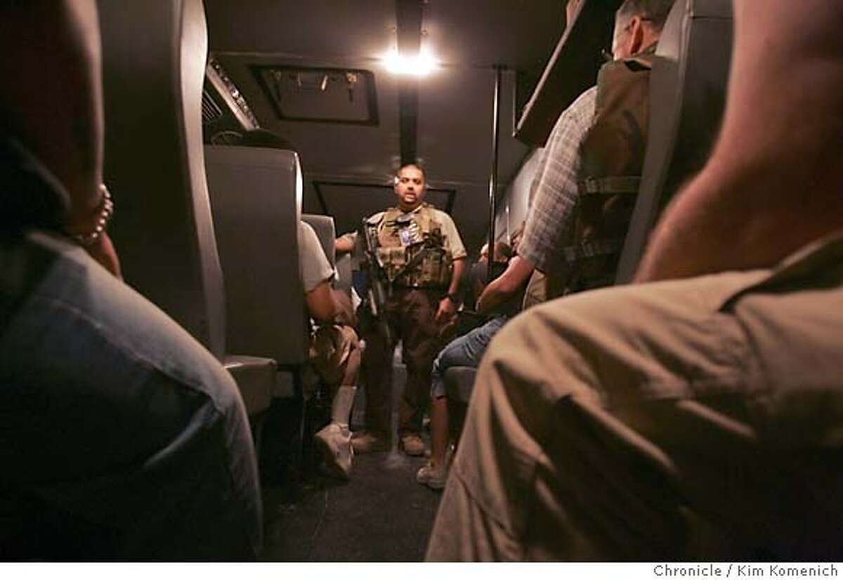 At Camp Stryker,Special Agent Ricardo Gibert (cq) of the Diplomatic Security Services of the U.S. Department of State briefs rhino passengers on attack scenarios before the convoy departs for the International Zone in Baghdad Soldiers and civilian contractors board the "Rhino", a heavily armored Winnebago-looking bus and begin a heavily guarded convoy from Camp Stryker at the Baghdad Airport to the International Zone in downtown Baghdad. The three Rhinos were escorted by two helicopters and several Bradley fighting vehicles. San Francisco Chronicle Photo by Kim Komenich 9/23/05
