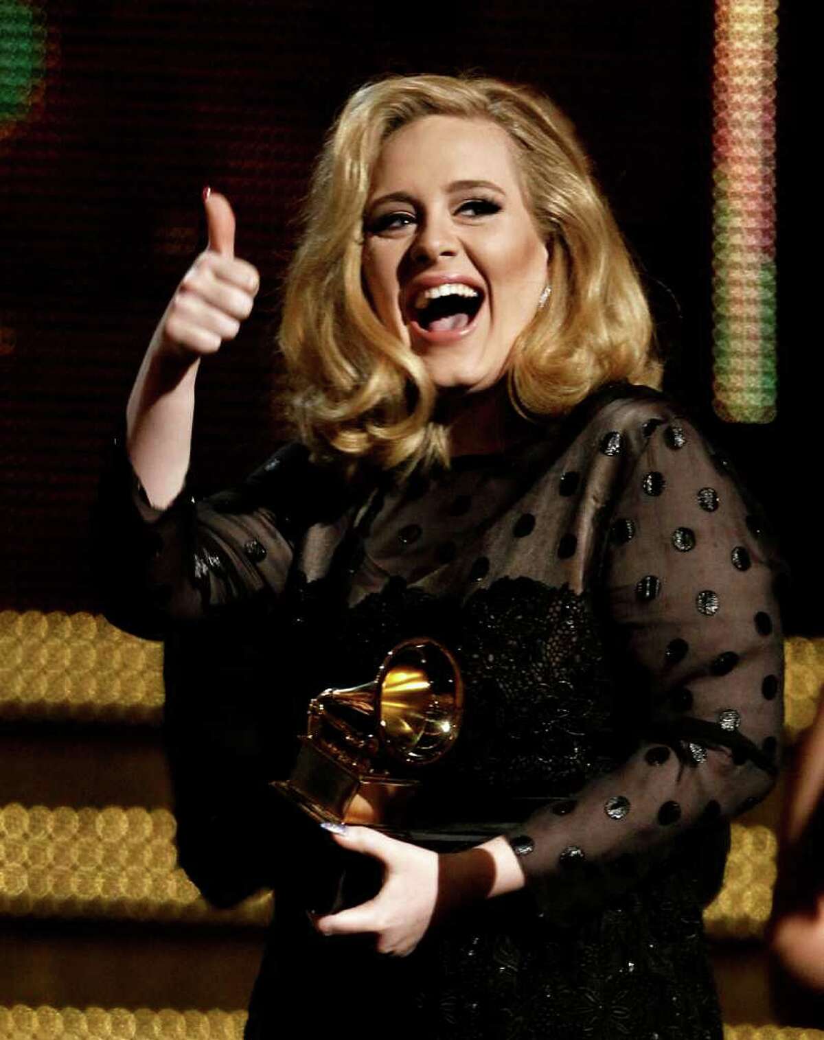 Adele accepts the award for record of the year for "Rolling in the Deep" during the 54th annual Grammy Awards on Sunday, Feb. 12, 2012 in Los Angeles. (AP Photo/Matt Sayles)