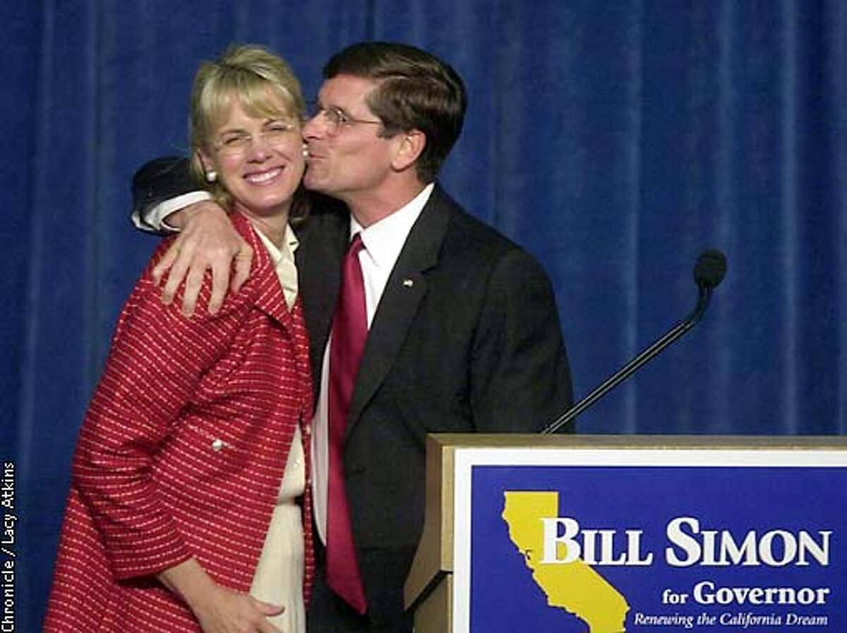 GOVELECT8-05MAR02-MN-LA Republican Govenor canidate Bill Simon gives his wife Cindy a kiss as he thanks her for her help in the election at his victory speech. PHOTO BY LACY ATKINS/CHRONICLE