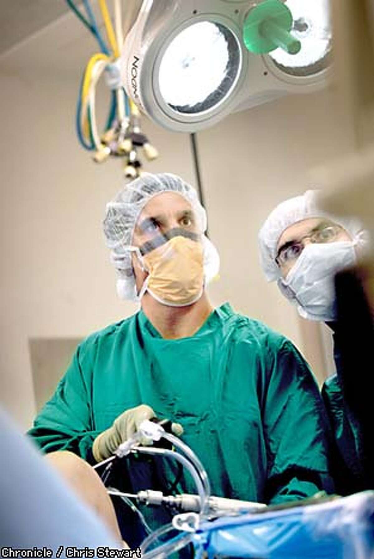 On the case: Dr. Eric Heiden watches a monitor as he performs orthopedic surgery at UC Davis Medical Center. Chronicle photo by Chris Stewart