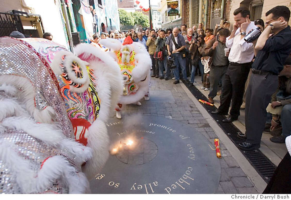 Lion Dancers dance near the lighting of the firecrackers going off in the middle of Jack Kerouac Alley with Mayor Gavin Newsom plugging his ears at 2nd from right as a crowd of hundreds attend the Jack Kerouac Alley Dedication for the newly restored Jack Kerouac Alley between Grant and Coumbus in North Beach, which was attended by community leaders and local residents from North Beach and Chinatown and included entertainment and festivities from 12:00 to 4:00 p.m. in San Francisco, CA, on Saturday, March, 31, 2007. photo taken: 3/31/07 Darryl Bush / The Chronicle ** Gavin Newsom (cq)