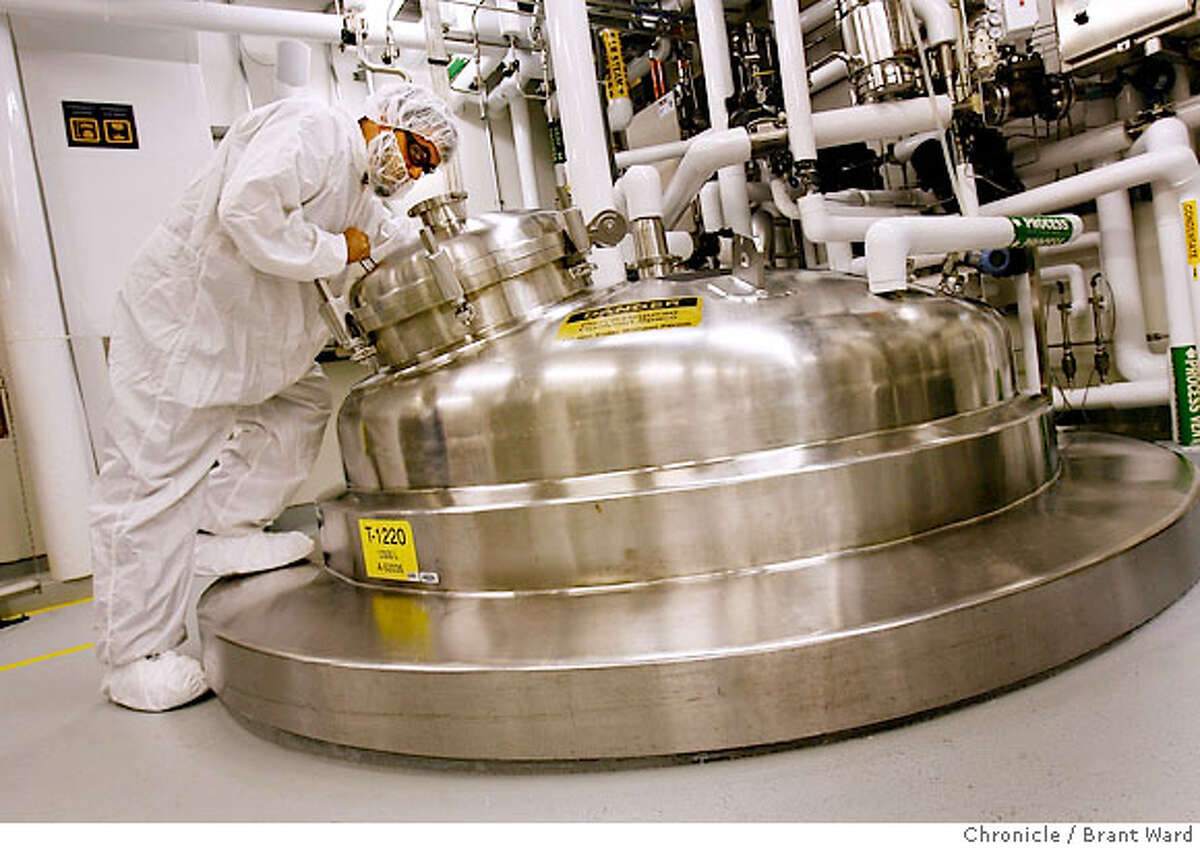 Derek Cinpak stares into a 12,000 litre bioreactor which holds cell culture fluid, the place where they create the cells necessary to manufacture the drugs at Genentech. The complex process of manufacturing biotechnology drugs goes on every day at Genentech in South San Francisco. While there is no procedure at the FDA to approve generic versions of biotech drugs, there is pressure from Congress to create an FDA process to bring cheaper generic versions of biotech drugs to market. {Brant Ward/San Francisco Chronicle}7/5/07 Ran on: 07-15-2007 Derek Cinpak looks into a 12,000-liter bioreactor, which holds cell culture fluid used to manufacture drugs at Genentech. Ran on: 07-14-2007 Ran on: 07-14-2007