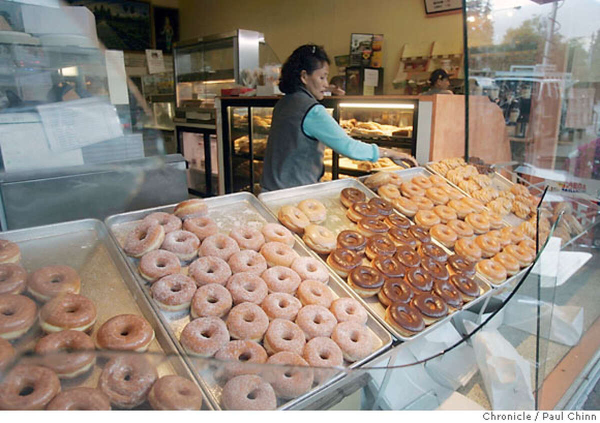 Employee Caterina Siek looks at the broken window at Dream Fluff donut shop in Berkeley, Calif. after a pre-dawn earthquake measuring 4.2 rattled the Bay Area on Friday, July 20, 2007. PAUL CHINN/The Chronicle **Caterina Siek