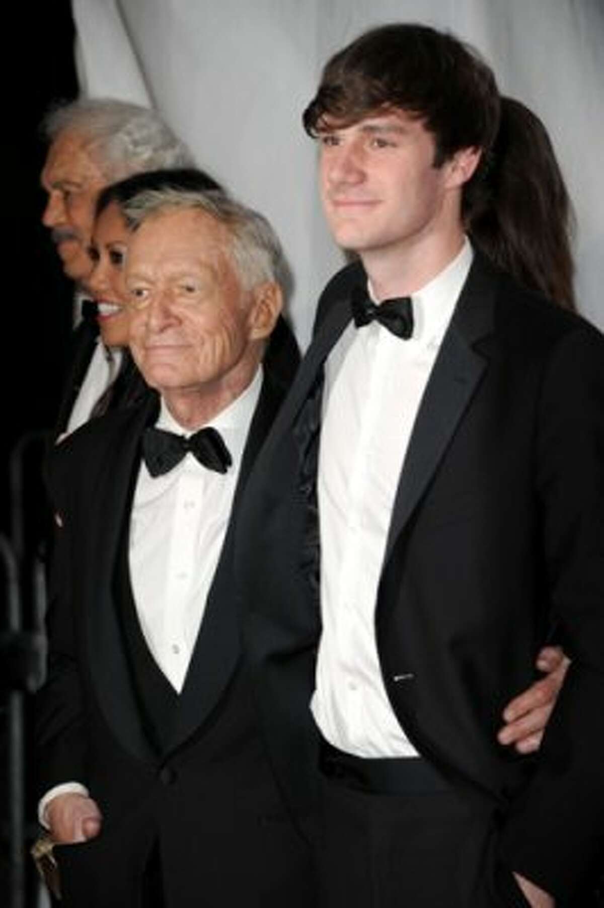 Hugh Hefner, left, and his son Cooper Hefner arrive at the 2012 MusiCares Person of the Year Tribute To Paul McCartney held at the Los Angeles Convention Center on Feb. 10, 2012, in Los Angeles. (Jason Merritt / Getty Images)