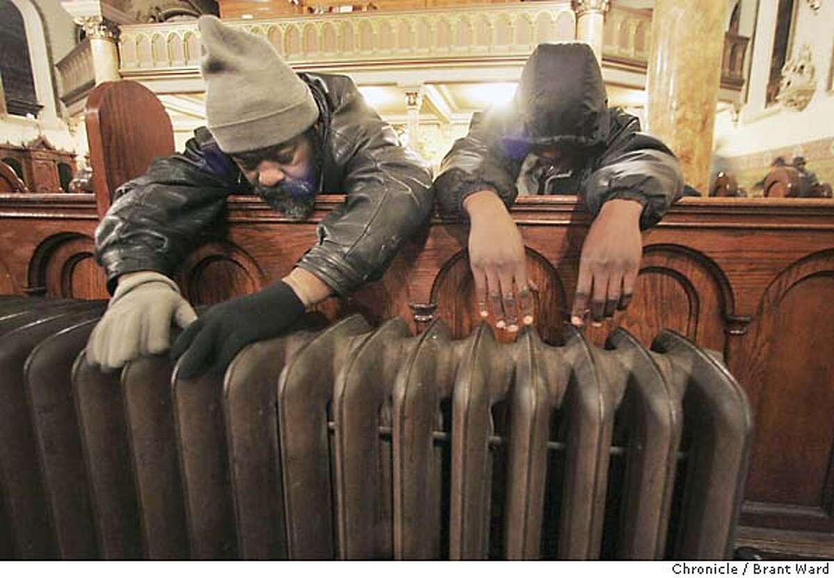 The first order of business for many of the lost souls seeking refuge at St. Boniface in the morning, after a chilly night outside, is warming their hands over the church's old radiators. Chronicle photo by Brant Ward