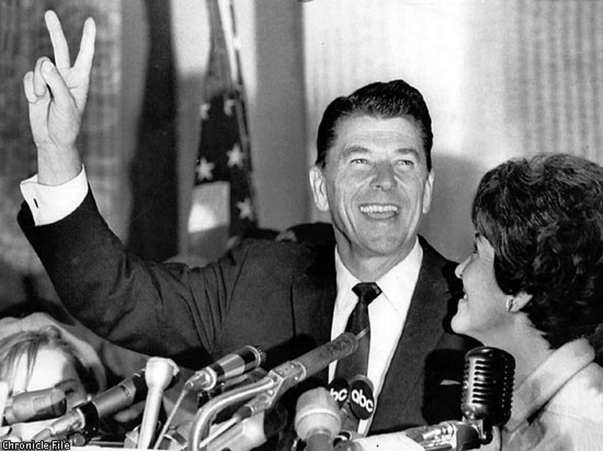 Ronald Reagan flashes the victory sign after he won the governorship of California over incumbent democratic governor Edmund G. (Pat) Brown. Reagan's wife, Nancy, is at right.