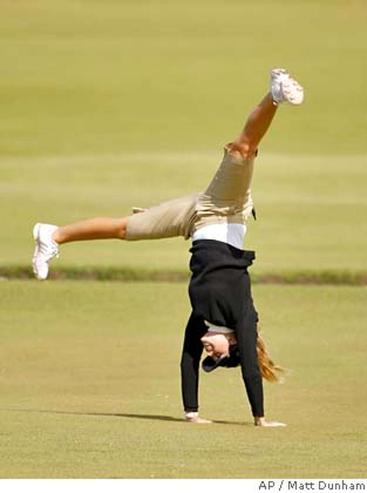 Paula Creamer of the U.S. performs a cartwheel on the 18th hole as she poses for a photographer after a Pro Am event ahead of the Women's British Open golf tournament at the Old Course at the Royal and Ancient Golf Club in St Andrews, Scotland, Wednesday, Aug. 1, 2007. The tournament begins on Thursday. (AP Photo/Matt Dunham) ** EDITORIAL USE ONLY ** EDITORIAL USE ONLY