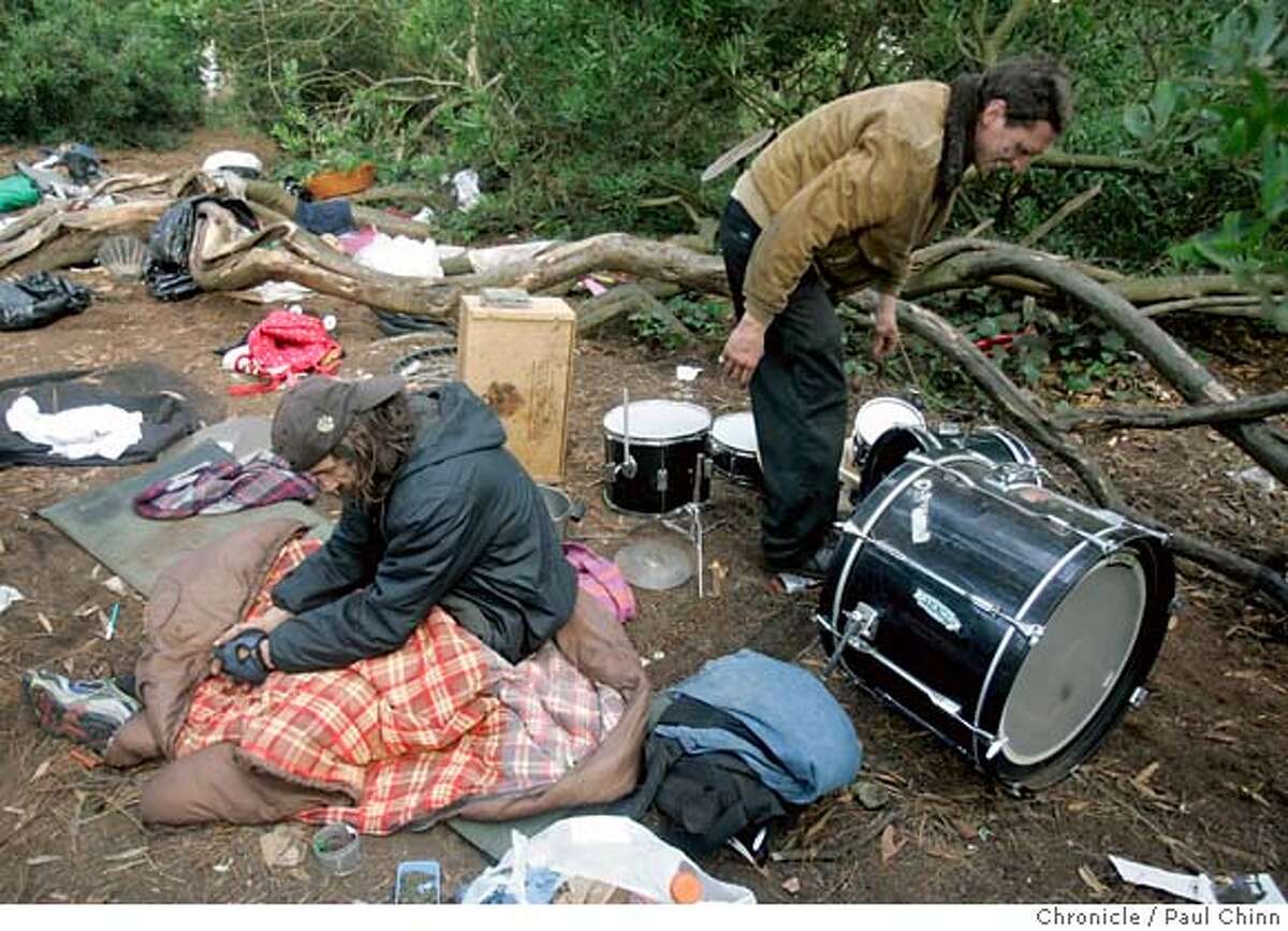 Christopher Ash (right) arranges his drum set as an unidentified neighbor wakes up at a homeless encampment at Golden Gate Park in San Francisco, Calif. on Friday, July 20, 2007. PAUL CHINN/The Chronicle **Christopher Ash MANDATORY CREDIT FOR PHOTOGRAPHER AND S.F. CHRONICLE/NO SALES - MAGS OUT