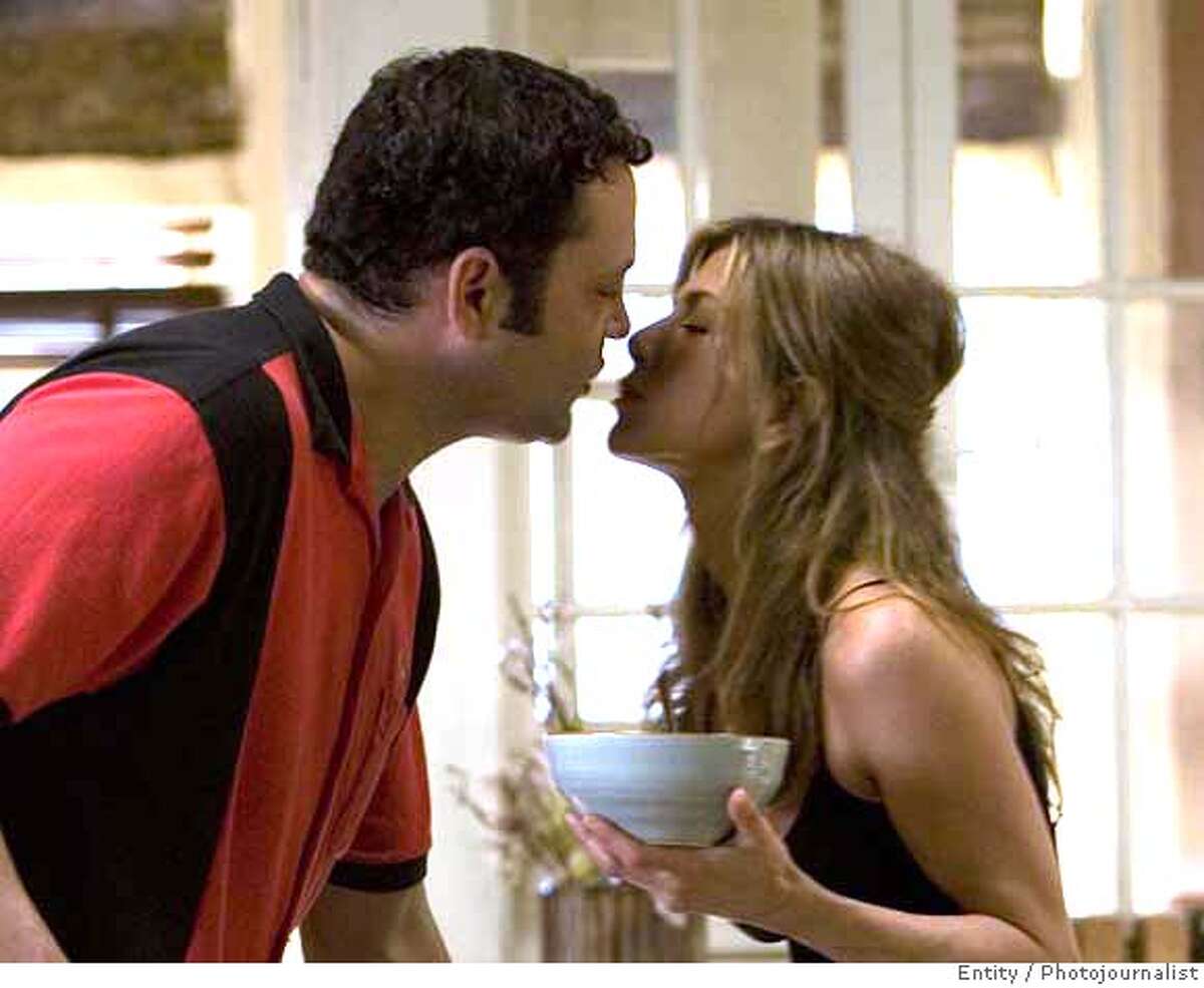 Bus tour guide Gary Grobowski (VINCE VAUGHN) and art dealer Brooke Meyers (JENNIFER ANISTON) prepare for a family dinner in the romantic comedy "The Break-Up". "The Break-Up" will be released in theaters on June 2, 2006. Credit: Melissa Moseley/UNIVERSAL STUDIOS