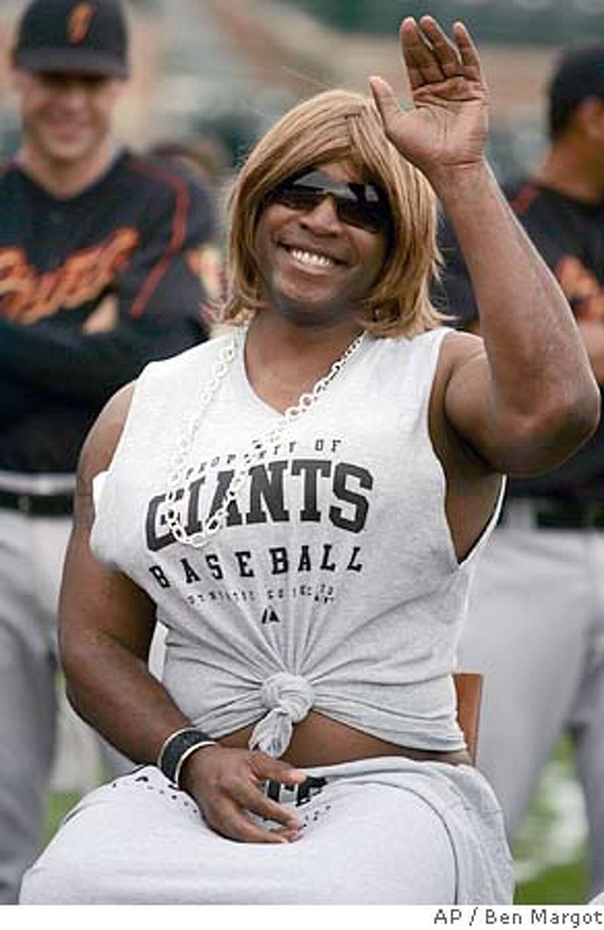 Dressed in drag portraying Paula Abdul on "American Idol," San Francisco Giants left fielder Barry Bonds waves to fans as he participates in a rookie hazing spoof of the hit television show for a second day prior to a Major League baseball spring training workout Wednesday, March 1, 2006, in Scottsdale, Ariz. (AP Photo/Ben Margot) EFE OUT