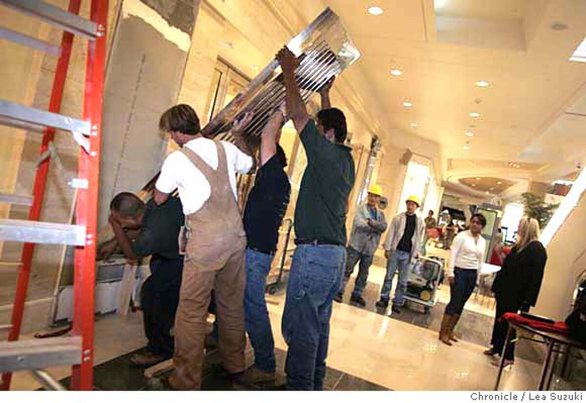 Workers from Skyline Construction in San Francisco work on the exterior of Parasuco in the Westfield San Francisco Shopping Centre the day before opening day. Bloomingdale's Private Preview Day and workers getting Westfield San Francisco Center ready on Wednesday, September 27, 2006. The 24-hour countdown to the biggest shopping event in San Francisco in decades began at 9 a.m. Wednesday. Photo by Lea Suzuki/The San Francisco Chronicle Photo taken on 9/27/06, in San Francisco, CA. **(themselves) cq.