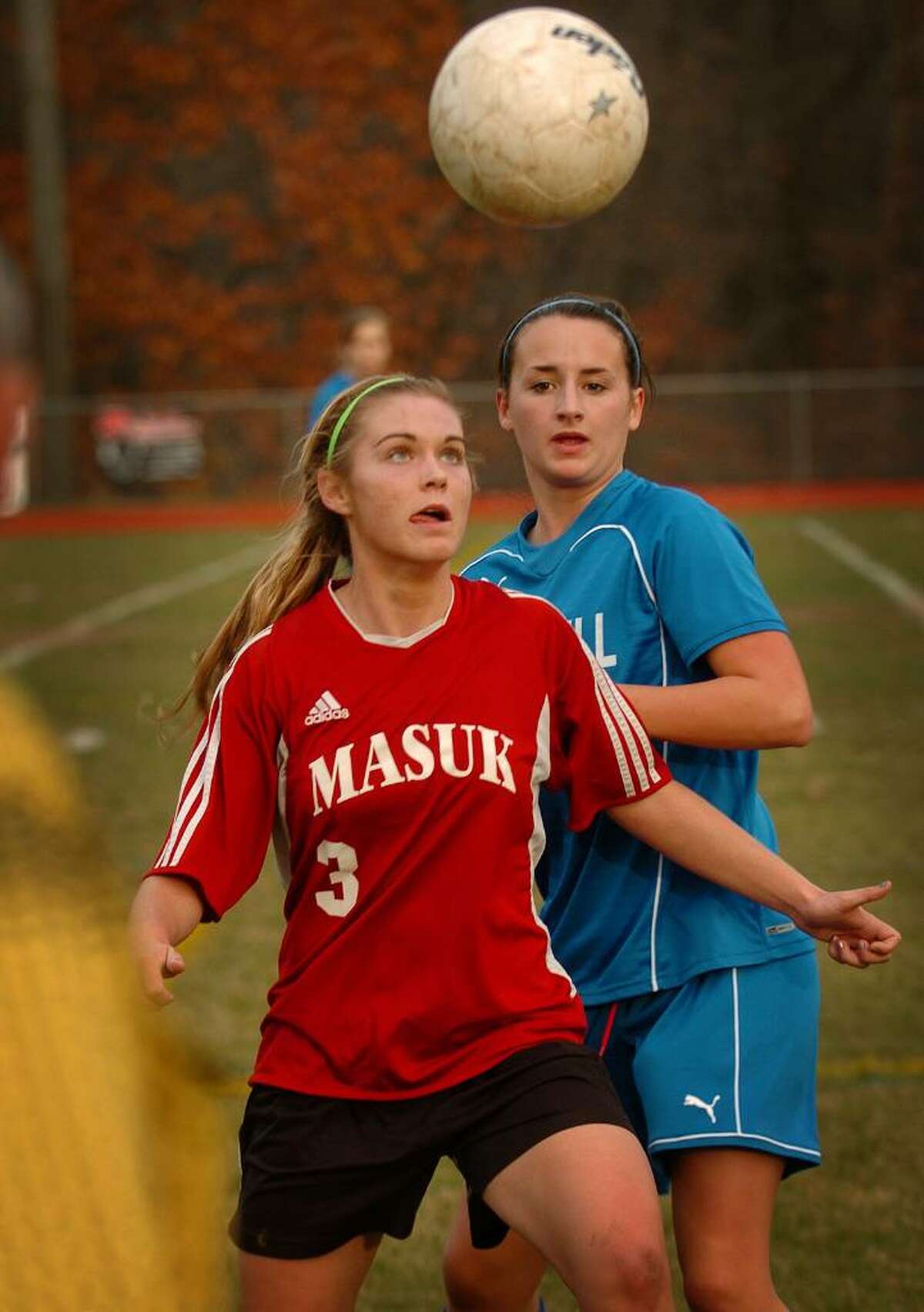 Masuk's Collen Coubren eyes the ball in front of Bunnell defender Megan Murphy during Monday's matchup in the opening round of the Class L state playoffs at Masuk High School in Monroe.