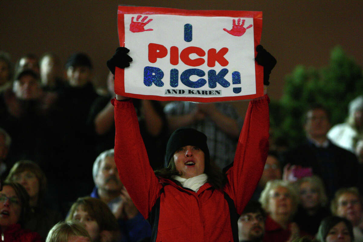 A supporter of Republican Presidential candidate Rick Santorum holds up a sign during a rally on Monday February 13, 2012 at the Washington State History Museum in Tacoma. Santorum gave a speech outside the museum Monday night. The event was partly crashed by Occupy protesters and a woman that dumped glitter on the candidate.