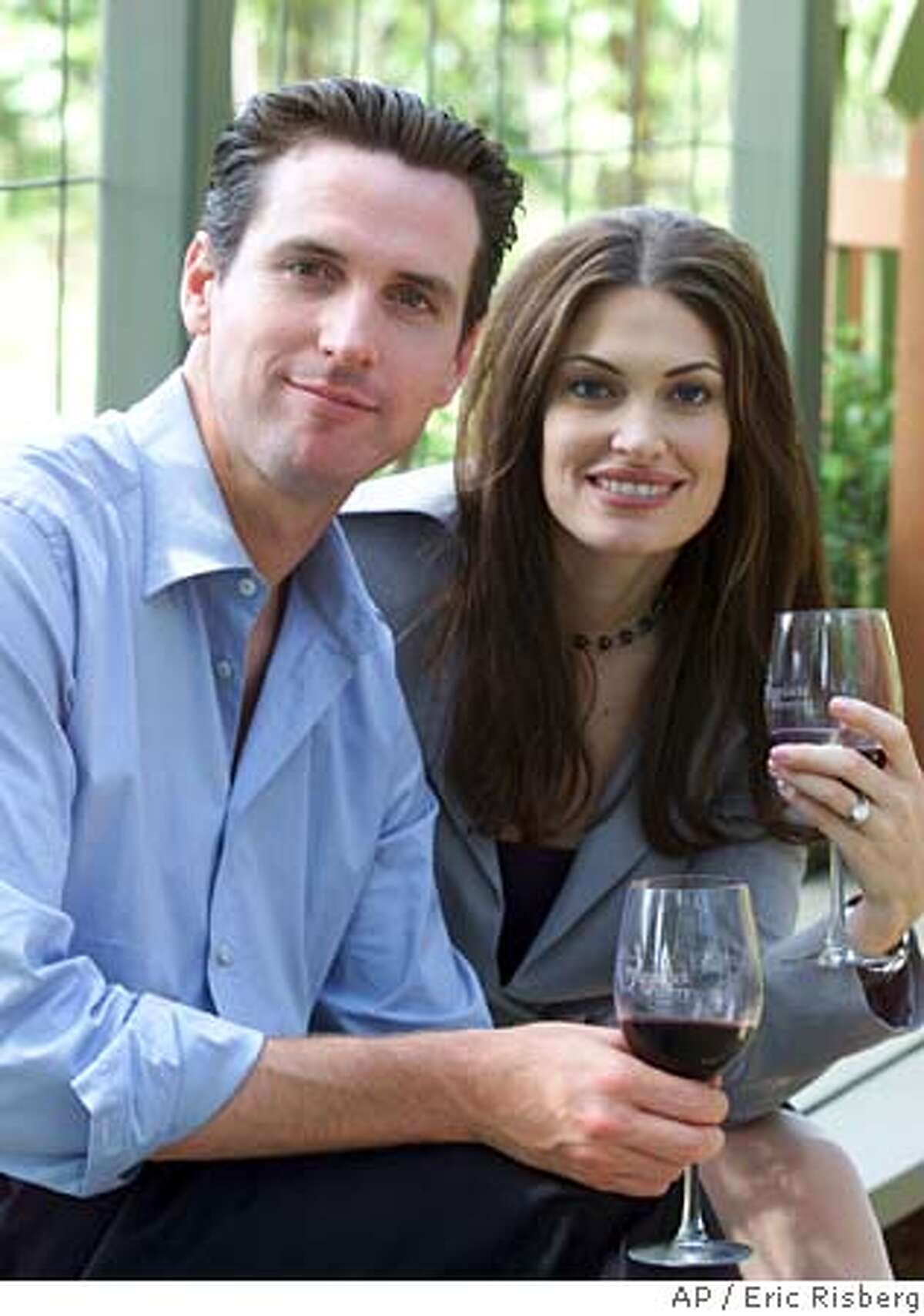 Gavin Newsom, left, and his wife, Kimberly Guilfoyle Newsom, right, pose for a picture at the PlumpJack winery in Oakville, Calif., Friday June 7, 2002. San Francisco Mayor Gavin Newsom and his wife, Court TV legal analyst Kimberly Guilfoyle Newsom, are filing for divorce after three years of marriage. In a joint statement issued Wednesday by the mayor's office, the Newsoms cited the strain posed by their high-profile, bicoastal careers as the reason for the split. (AP Photo/Eric Risberg) A JUNE 7 2002 PHOTO Ran on: 01-06-2005 Mayor Gavin Newsom and wife Kimberly Guilfoyle Newsom are getting divorced.