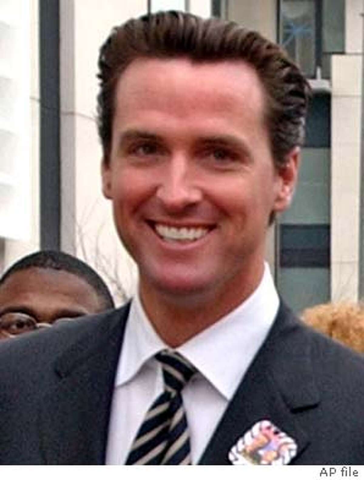 ** FILE ** San Francisco Mayor Gavin Newsom, left, new San Francisco District Attorney Kamala Harris, right, and Rev. Cecil Williams, center, of the Glide Memorial Methodist Church, in San Francisco, help lead a march in San Francisco celebrating Dr. Martin Luther King, Jr., Monday, Jan. 19. 2004. As San Francisco's youngest mayor in more than a century, Newsom pledged to usher in a new generation of leadership. But it's the gender of his appointees, not their ages, that is raising eyebrows here and beyond. Newsom, a 36-year-old Democrat, has promoted women to lead both the police and fire departments, a national first for a city anywhere near San Francisco's size. (AP Photo/Paul Sakuma) Gavin Newsom