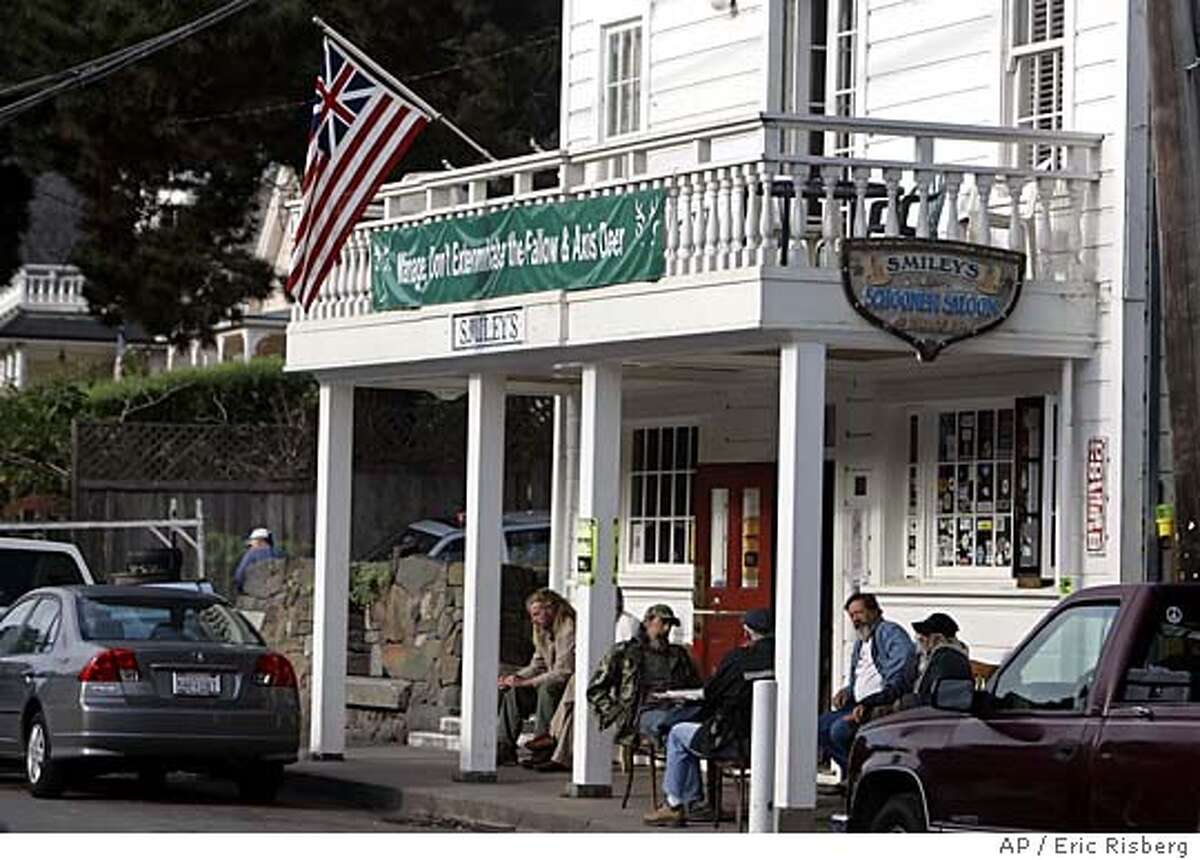 A flag blending the Union Jack and the Stars and Stripes flies above Smiley's Schooner Saloon in Bolinas, Calif., where all is quiet for the of Prince Charles and the Duchess of Cornwall Saturday, Nov. 5, 2005. Later in the day the royal couple are scheduled to take a tour and have lunch at a nearby organic farm. (AP Photo/Eric Risberg)