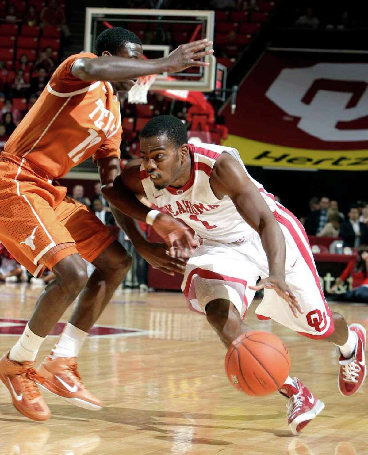 Oklahoma's Sam Grooms (1) tries to get by Texas' Myck Kabongo (12) during an NCAA college basketball game at the Lloyd Noble Center in Norman, Okla., Tuesday, Feb. 14, 2012. (AP Photo/The Oklahoman, Sarah Phipps) TABLOIDS OUT