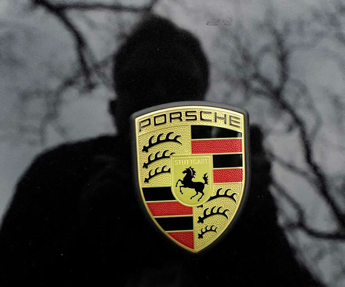 The Porsche emblem on the front end of a black Porsche convertible parked on Greenwich Avenue Wednesday, Feb. 15, 2012.