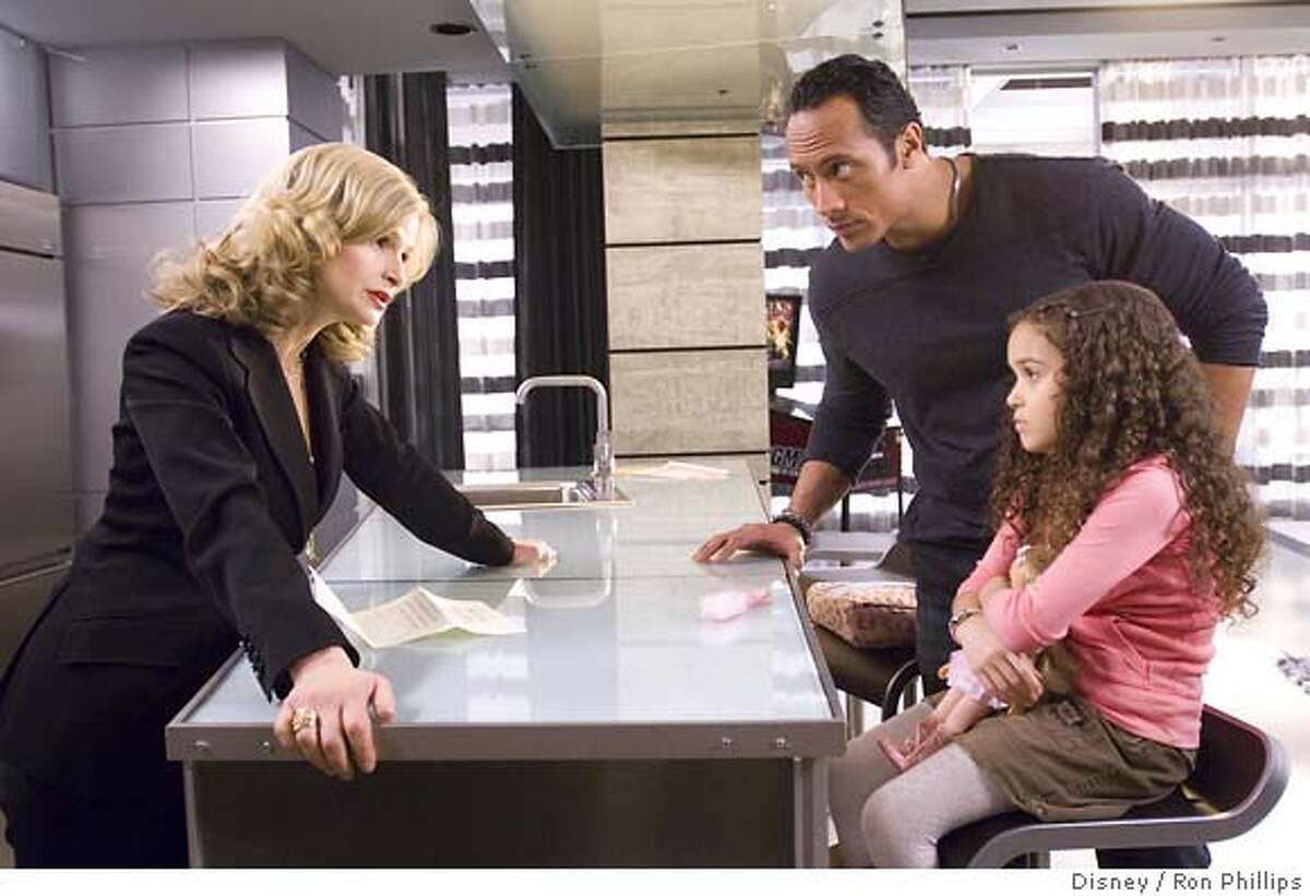 Disney provided this photo of (left to right) Kyra Sedgwick, Dwayne "The Rock" Johnson and Madison Pettis in "The Game Plan." (AP Photo/Disney/Ron Phillips)