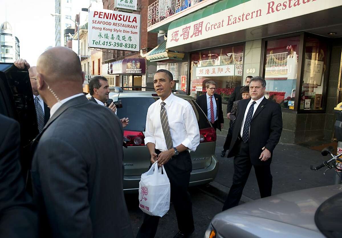 US President Barack Obama picks up a dim sum takeout lunch at the Great Eastern Restaurant in San Francisco's Chinatown on February 16, 2012. AFP PHOTO/Saul LOEB (Photo credit should read SAUL LOEB/AFP/Getty Images)