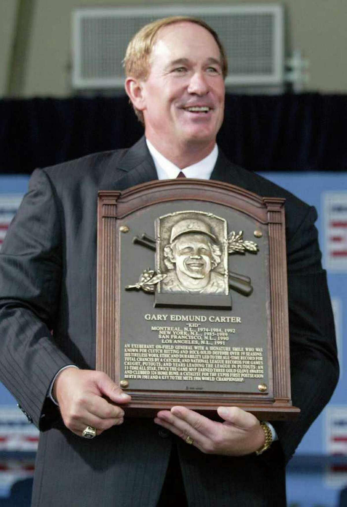 FILE - In this July 27, 2003, file photo, National Baseball Hall of Fame Inductees Gary Carter holds his plaque during induction ceremonies in Cooperstown, N.Y. Baseball Hall of Fame president Jeff Idelson said Thursday, Feb. 16, 2012, that Hall of Fame catcher Gary Carter has died. He was 57.(AP Photo/John Dunn, File)