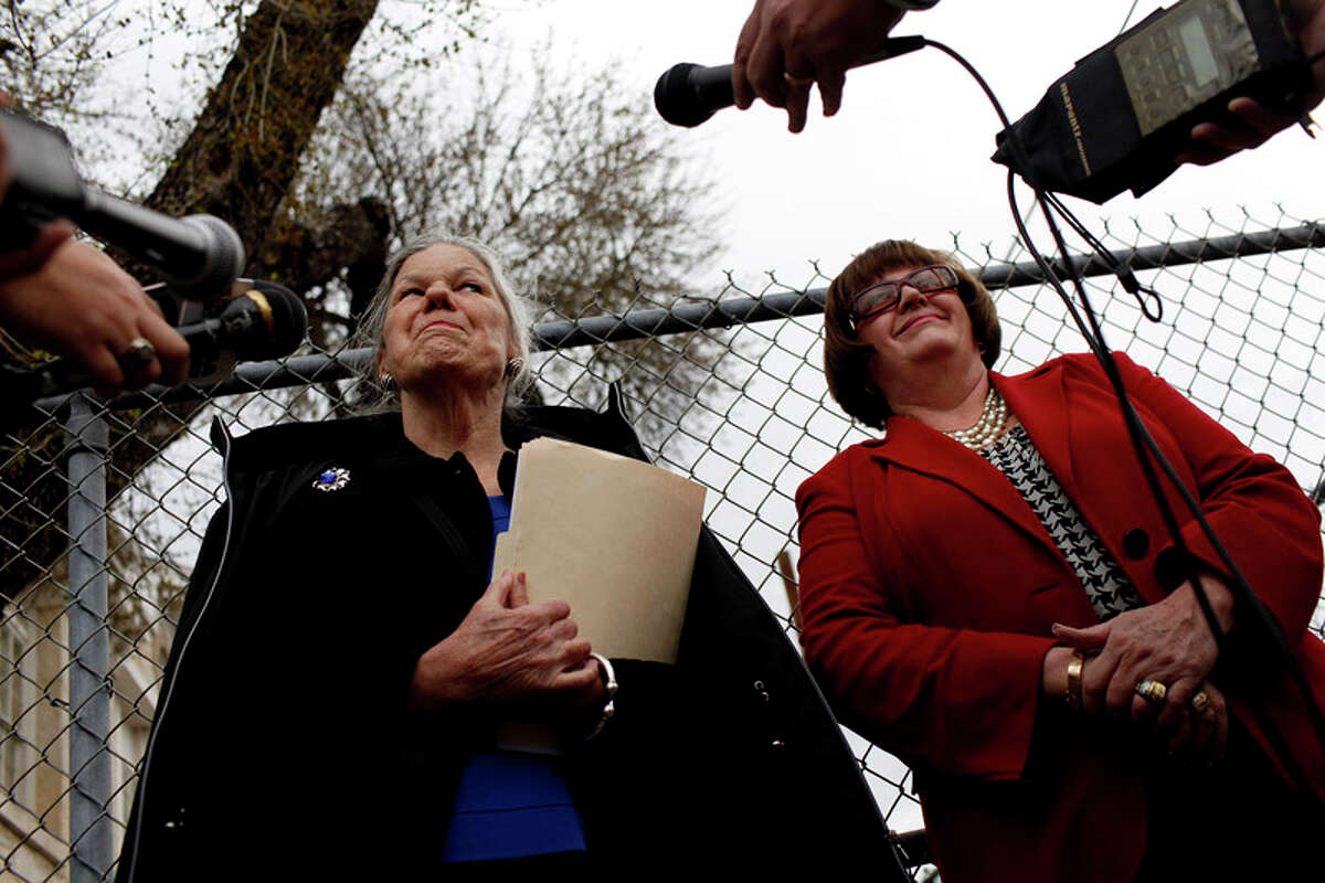 Concerned San Antonio Independent School District residents and taxpayers including Sally Buchanan (left), with San Antonio Conservation Society President Nancy Avellar (right), talk to the media about the Alamo Stadium issue outside the SAISD headquarters in San Antonio on Feb. 16, 2012.
