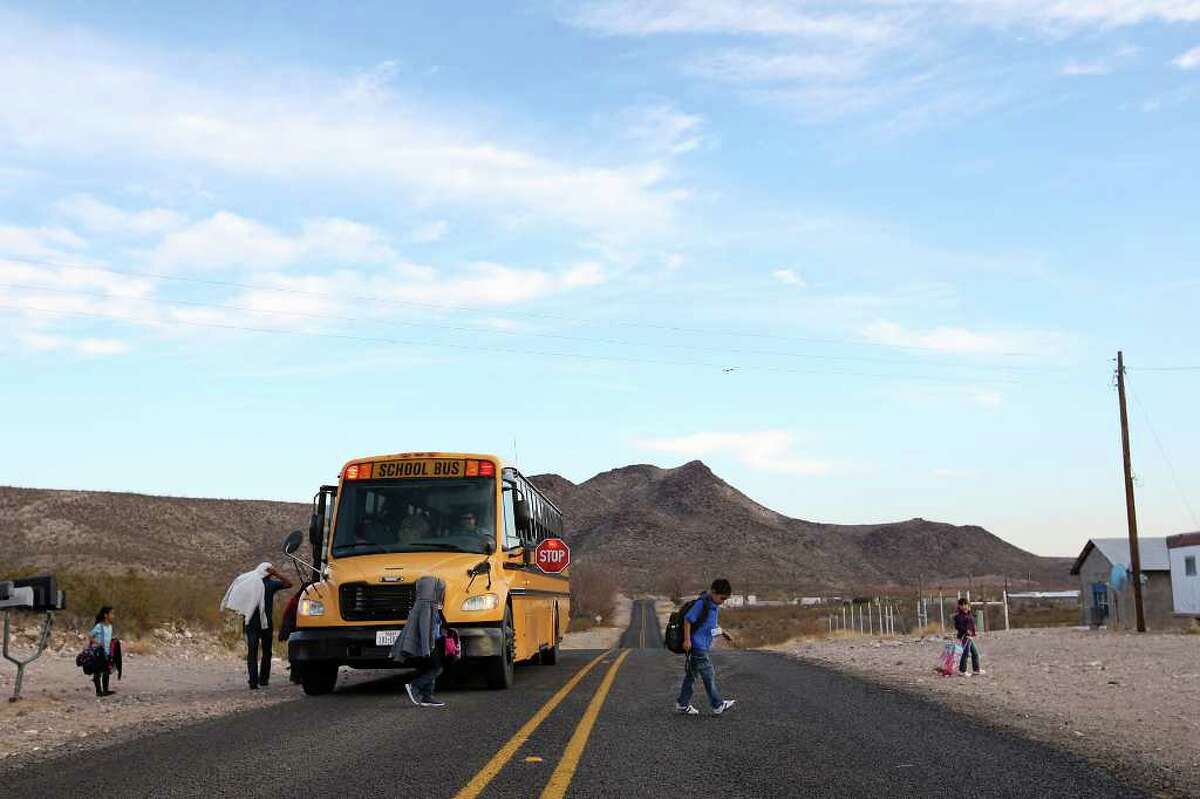 After a 50-mile ride, students are unloaded in Candelaria, Texas, Monday, Feb. 6, 2012. The town is located along the Rio Grande 42 miles southwest of Marfa, Texas. The Presidio County town lost its school in 1998 and students have since been bused over 50 miles to school in Presidio, Texas. Parent participation is at a minimal with the distance being a hardship. A Lutheran group is exploring the possibility of opening a charter school in the town.