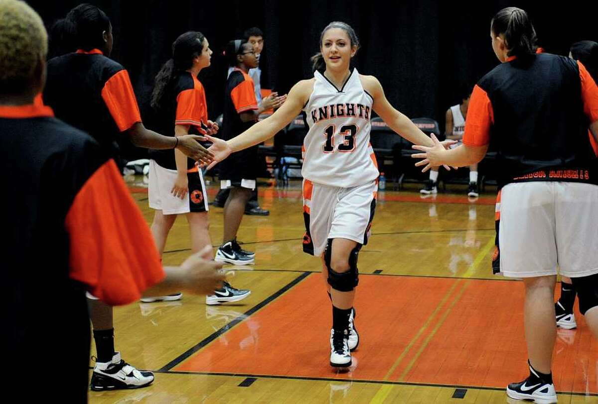 Stamford's Kelsey Cognetta is welcomed to the court by teammates before the girls basketball game at Stamford High School on Friday, January 6, 2012.