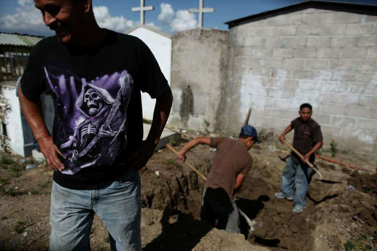 Men prepare graves for their relatives, inmates Renan and Jose Martinez, who died in a prison fire in Comayagua, Honduras. The toll in the blaze rose to 356 on Friday. Many who died were suspected gang members.