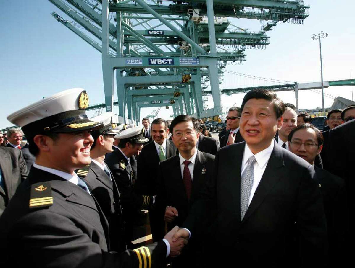 Chinese Vice President Xi Jinping, right, shakes hands with officers as he tours China Shipping at the Port Of Los Angeles in San Pedro, Calif., on Thursday.