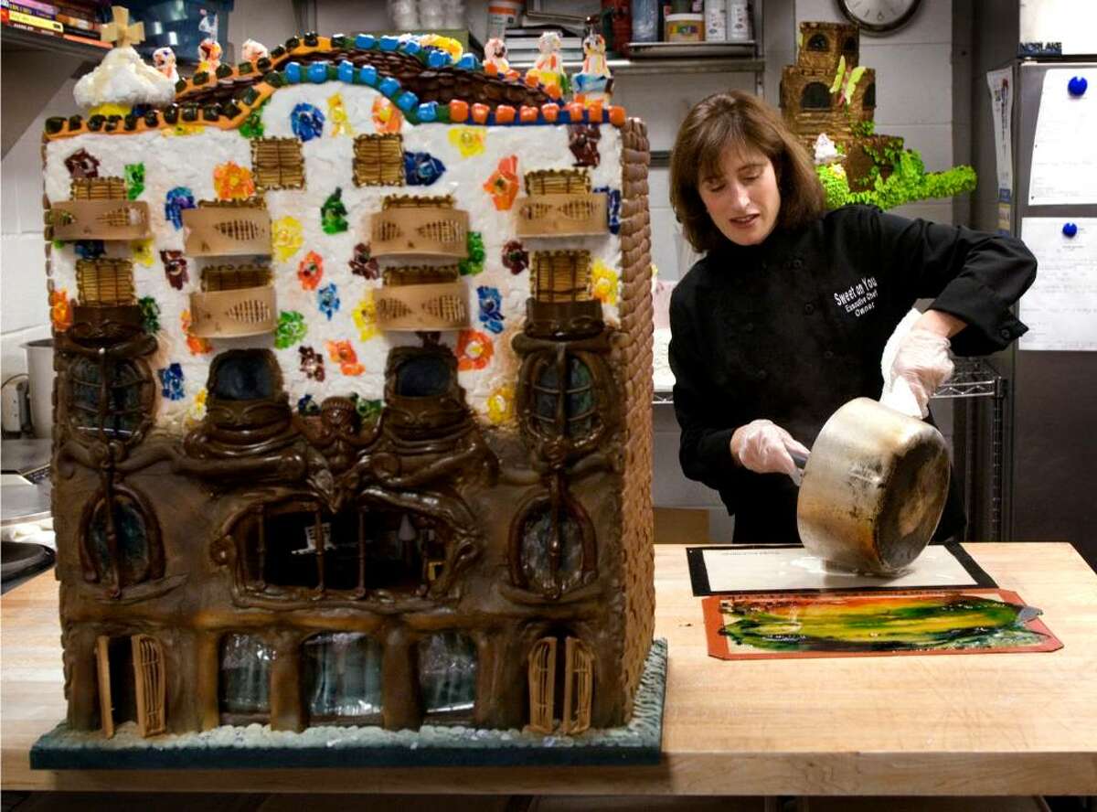 Rebecca Martin, owner of Sweet On You Bakery and Cafe in Stamford, Conn at the JCC, is one of several local chefs who have created gingerbread houses for the Stamford Museum & Nature Center's upcoming exhibit, "Visions of Gingerbread. She pours out sugar soulution that will harden and then she uses it to make the tile decorations on the Gaudi building she created.