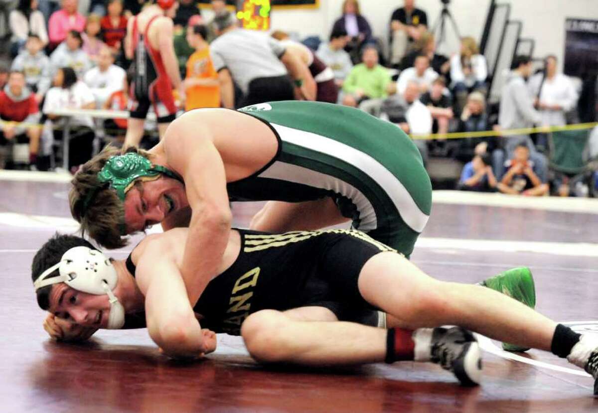 New Milford's Kameron Bradshaw is on top of Hand's Ben Onofrio in the 152-pound match of the Class L state wrestling championships at Bristol Central High School Saturday, Feb. 18, 2012.