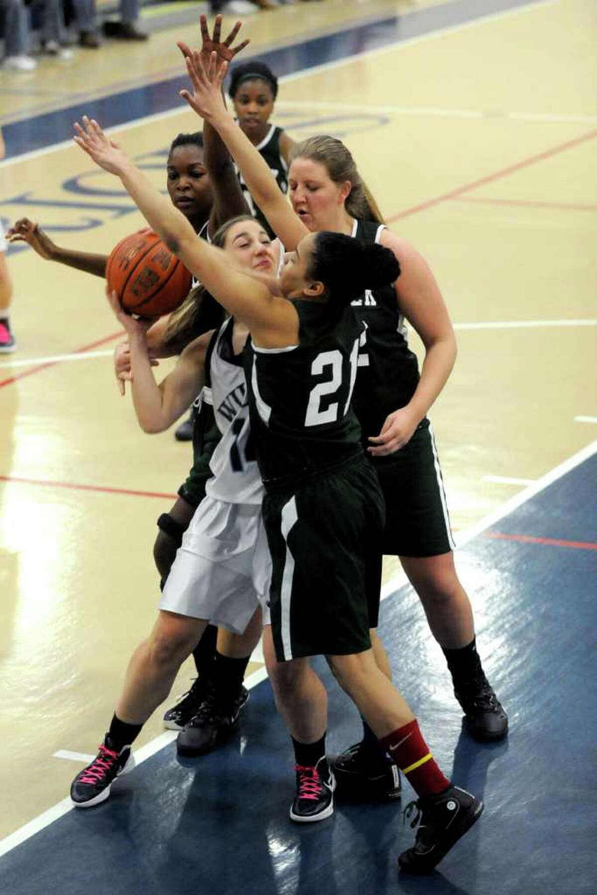Wilton's Alyssa Malvarossa is surrounded by Norwalk players during Saturday's FCIAC Girls Basketball quarterfinal game at Wilton High School on February 18, 2012.