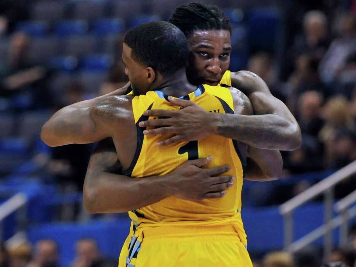 Marquette's Jae Crowder, right, hugs teammate Darius Johnson-Odom (1) at the end of an NCAA college basketball game against Connecticut in Hartford, Conn., Saturday, Feb. 18, 2012. Crowder and Johnson-Odom had 29 and 24 points for their team in their 79-64 win. (AP Photo/Jessica Hill)