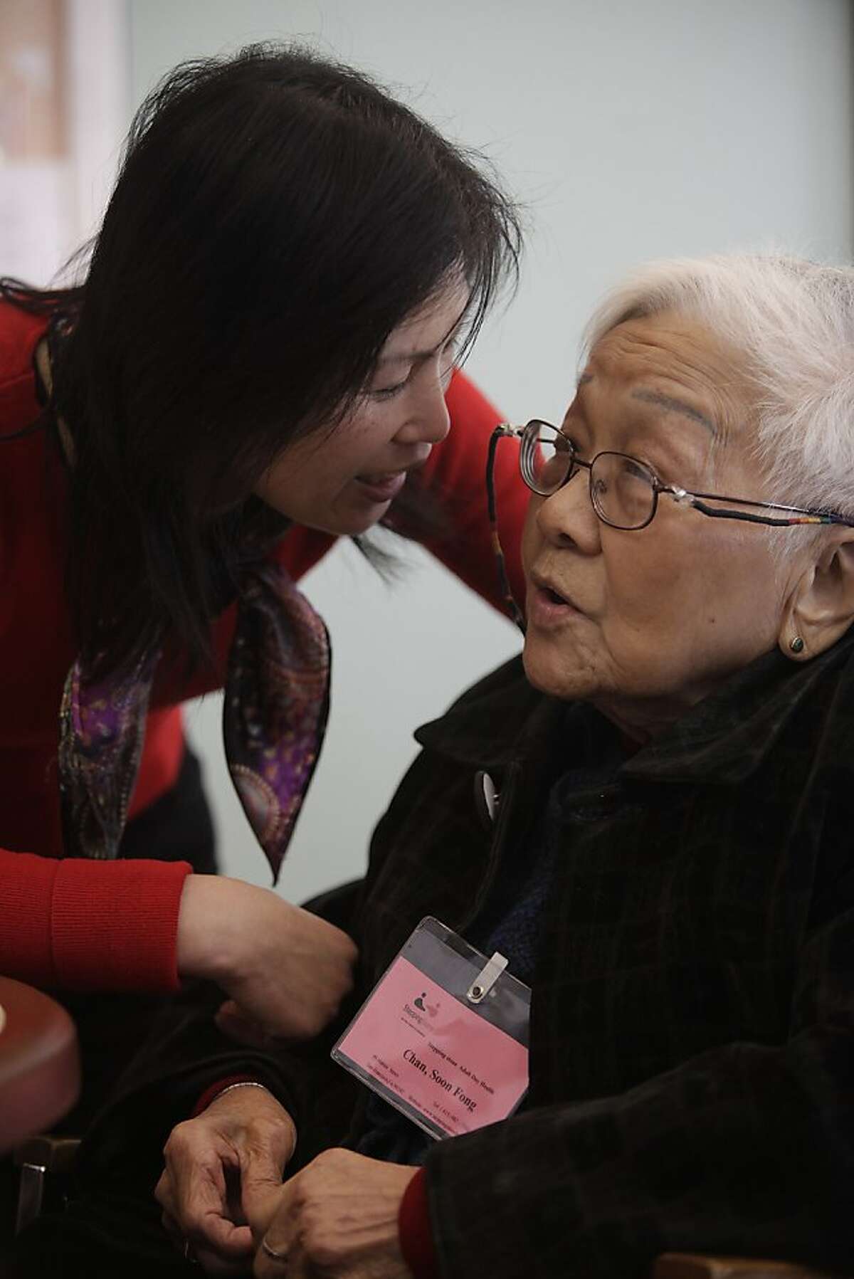 Mei Chen (l to r), activity coordinator, talks with Chan Soon Fong, 92, in the Day Room at the SteppingStone Mabini Day Health on Tuesday, February 14, 2012 in San Francisco, Calif.