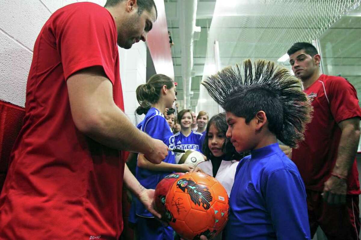 John-Anthony Coronado gets attention with an extreme hair style as he leads kids into an area off the field for autographs as the San Antonio Scorpions hold their first practice indoors at the Northwoods on February 18, 2012 Tom Reel/ San Antonio Express-News