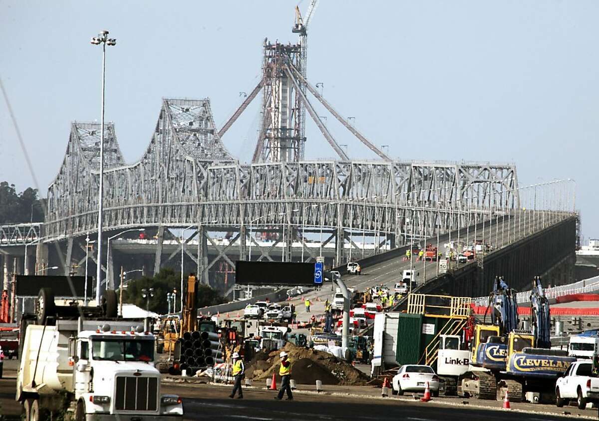 Caltrans employees and their sub-contractors work on the westbound lanes of the Bay Bridge road surface Saturday, February 18, 2012. Weather permitting, the bridge is expected to reopen early Tuesday morning.