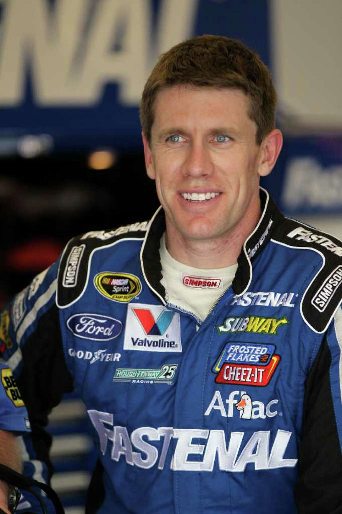 DAYTONA BEACH, FL - FEBRUARY 18: Carl Edwards, driver of the #99 Fastenal Ford, stands in the garage during practice for the NASCAR Sprint Cup Series Daytona 500 at Daytona International Speedway on February 18, 2012 in Daytona Beach, Florida. (Photo by Jamie Squire/Getty Images)