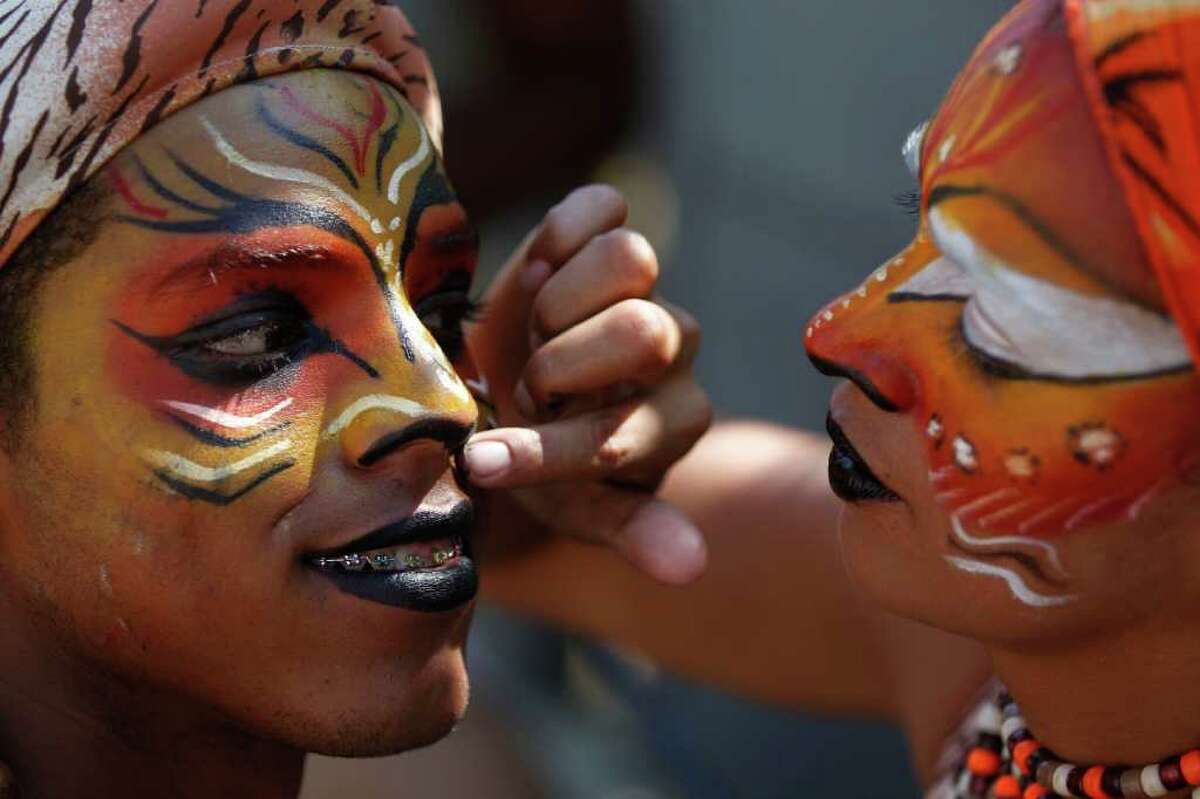People put on costume make-up for carnival celebrations in Barranquilla, Colombia, Sunday Feb. 19, 2012. The UNESCO declared Barranquilla's carnival a "Masterpiece of Oral and Intangible Heritage of Humanity" in 2003. (AP Photo/Fernando Vergara)