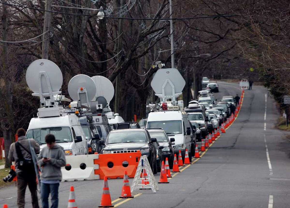 A long line of media vehicles line up to cover the burial of Whitney Houston at Fairview Cemetery for her burial in Westfield, N.J., Sunday, Feb. 19, 2012. (AP Photo/Rich Schultz)