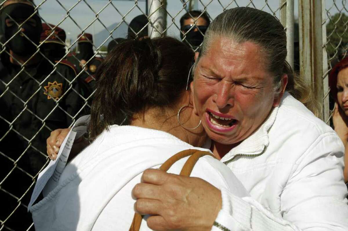 Relatives of inmates cry while waiting outside Apodaca prison, on February 19, 2012, near Monterrey, state of Nuevo Leon, Mexico. At least 38 inmates have been killed during a riot at a prison near the northern Mexican city of Monterrey, officials said. AFP PHOTO/Julio Cesar Aguilar (Photo credit should read Julio Cesar Aguilar/AFP/Getty Images)