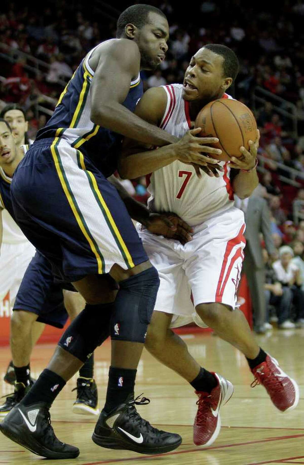 Utah's Paul Millsap roughs up Kyle Lowry, who burned the Jazz for 32 points Sunday night.