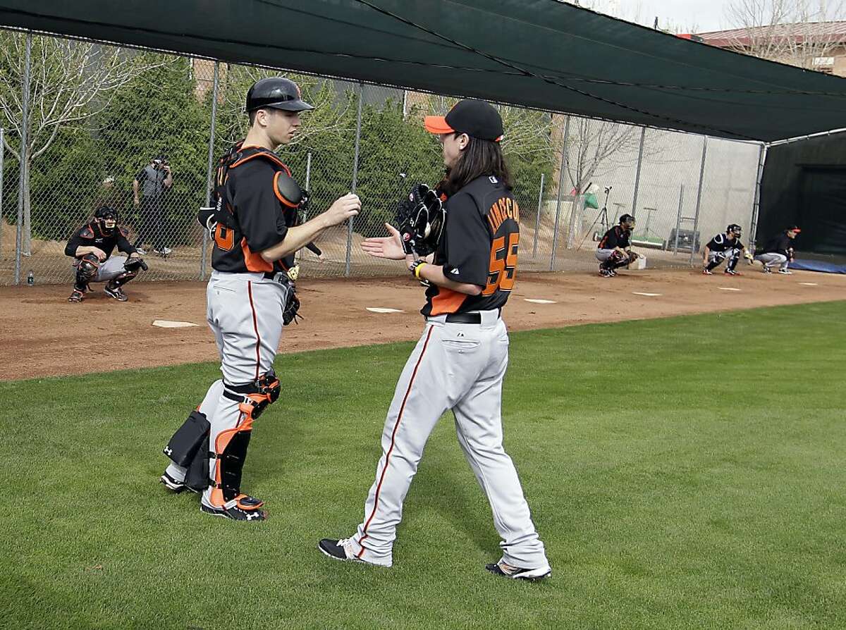 San Francisco Giants pitcher Tim Lincecum greets catcher Buster Posey after throwing during a baseball spring training workout Sunday, Feb. 19, 2012, in Scottsdale, Ariz. (AP Photo/Darron Cummings)